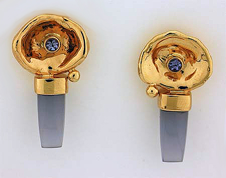 Custom 14K yellow gold watercast earrings set with a tanzanite and blue chalcedony bullets