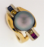 Custom black tahitian pearl ring with rainbow sapphires and rubies